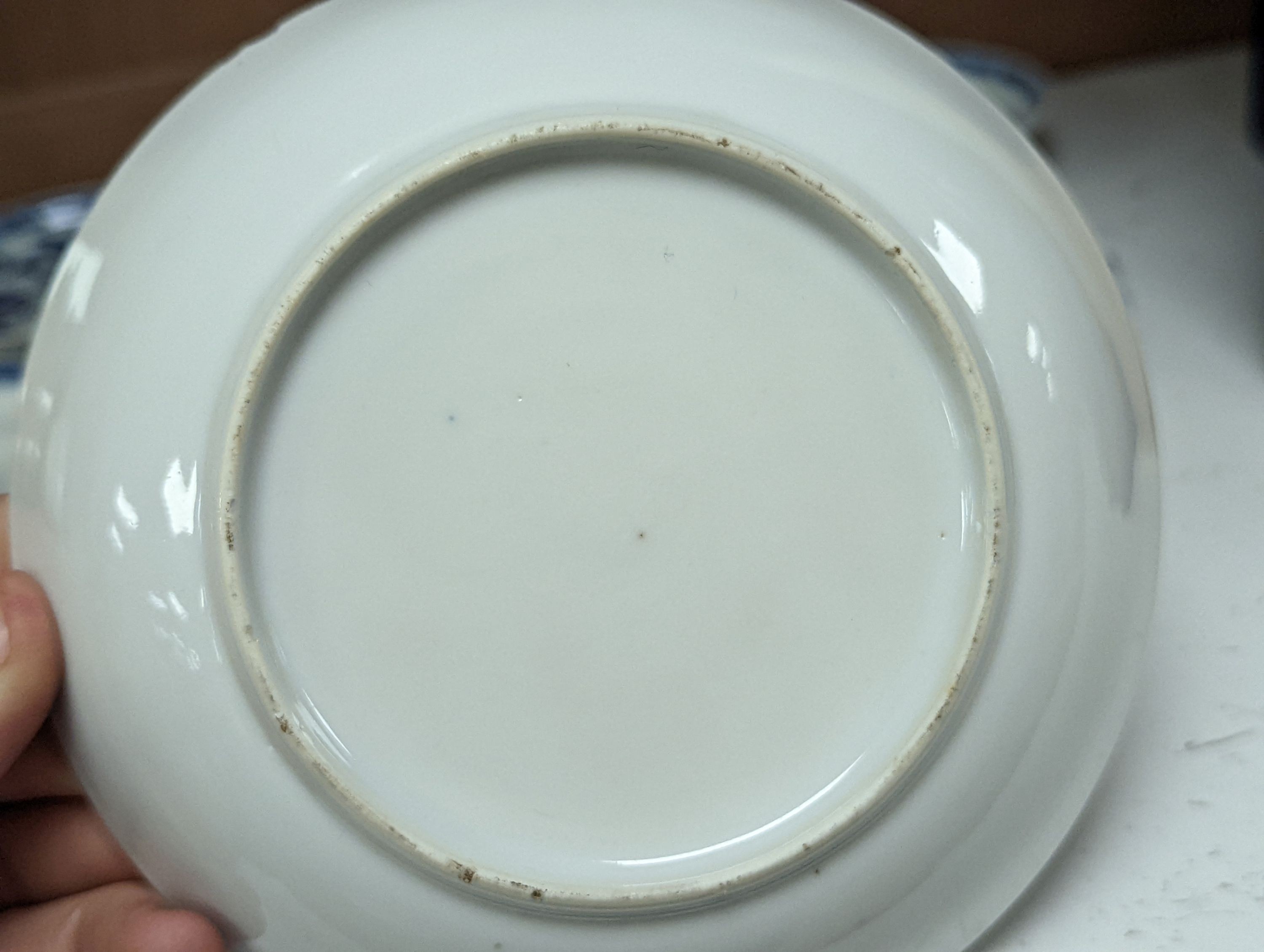 Seven 18th century Chinese saucer dishes, largest 14 cms diameter.
